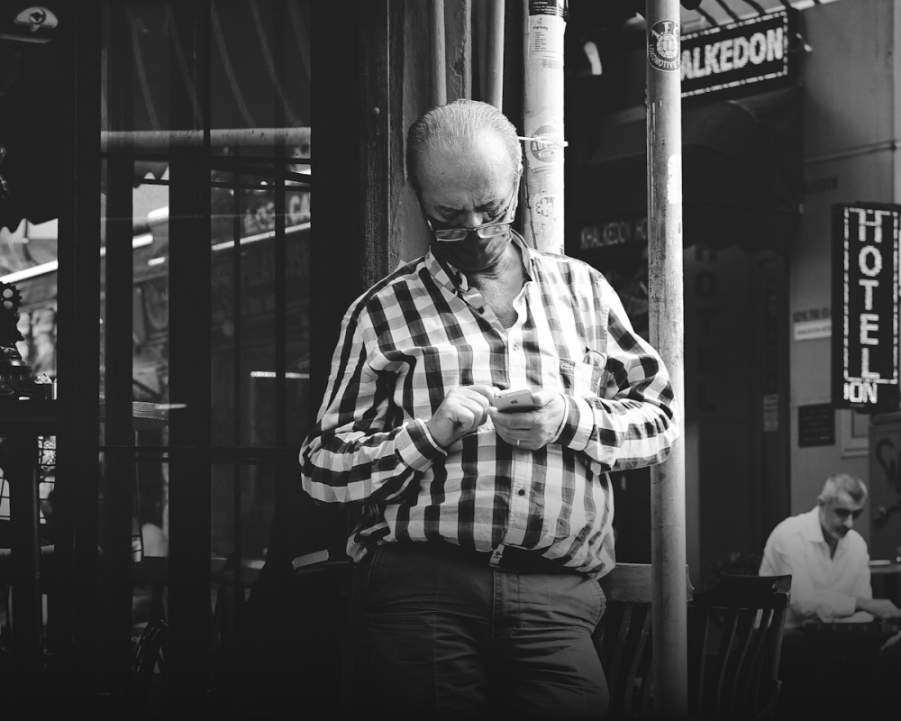 A user on the street, focused on his phone